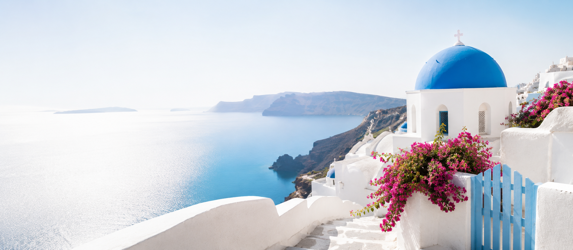 Greek island landscape with white houses, blue domes and sea